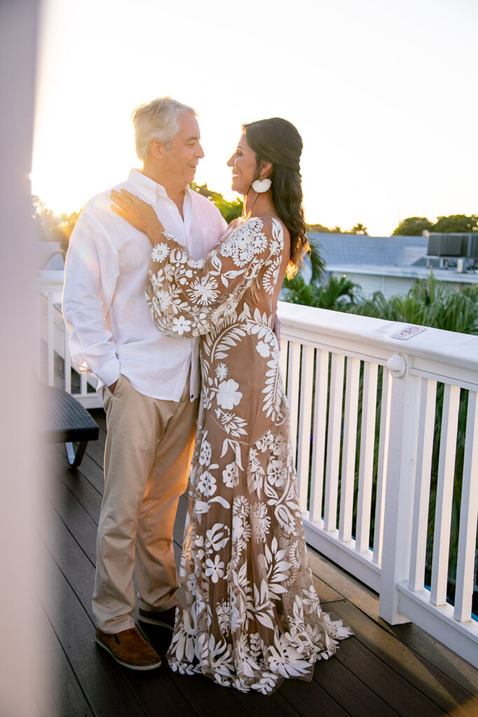 Bride and groom embracing on a rooftop in Key West during golden hour