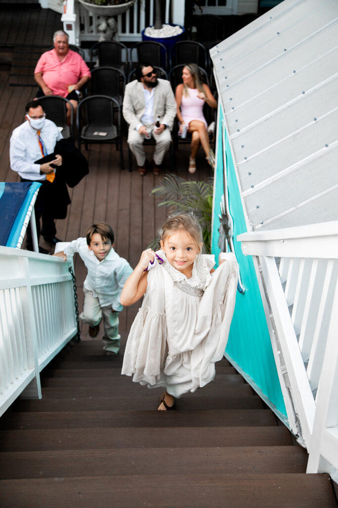 The ring bearer and flower girl excitedly running to see the bride and groom