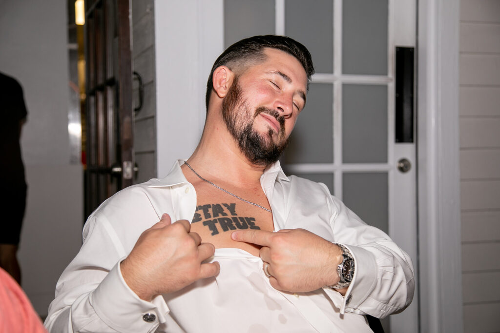 Wedding guest shows off his tattoo