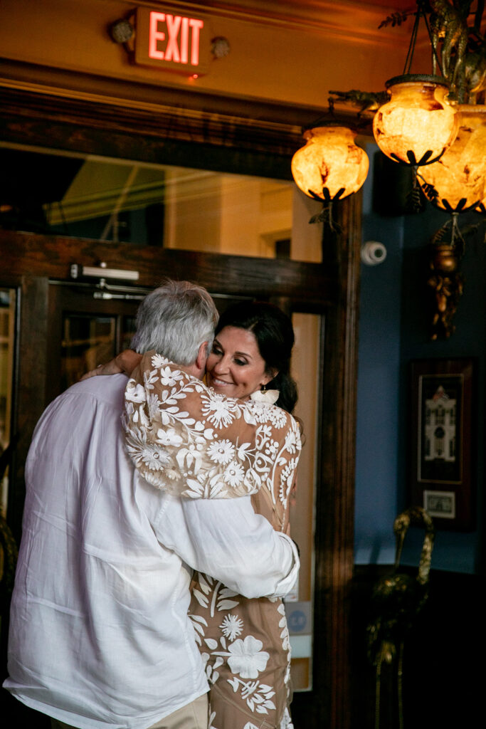 Bride embraces her new husband during their first dance