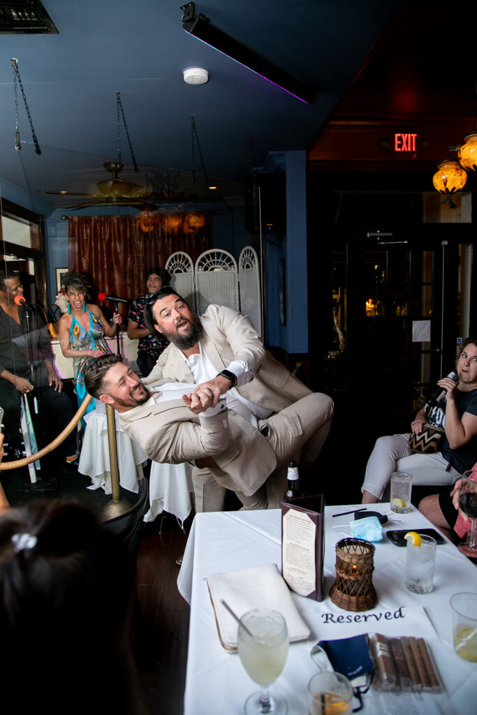 Bride's son dips his brother in an hilarious candid moment during the wedding reception in Key West