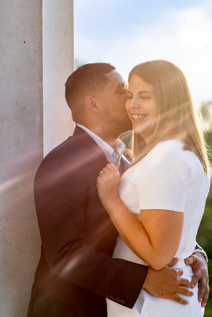 DC couple smiling and walking hand in hand at the Lincoln Memorial during their sunset engagement session