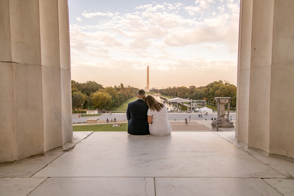DC couple sharing a quiet moment during their Lincoln Memorial engagement session with soft golden light