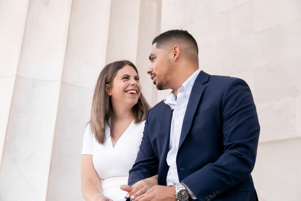 Close-up of engaged couple hugging and smiling during golden hour at the Lincoln Memorial in DC