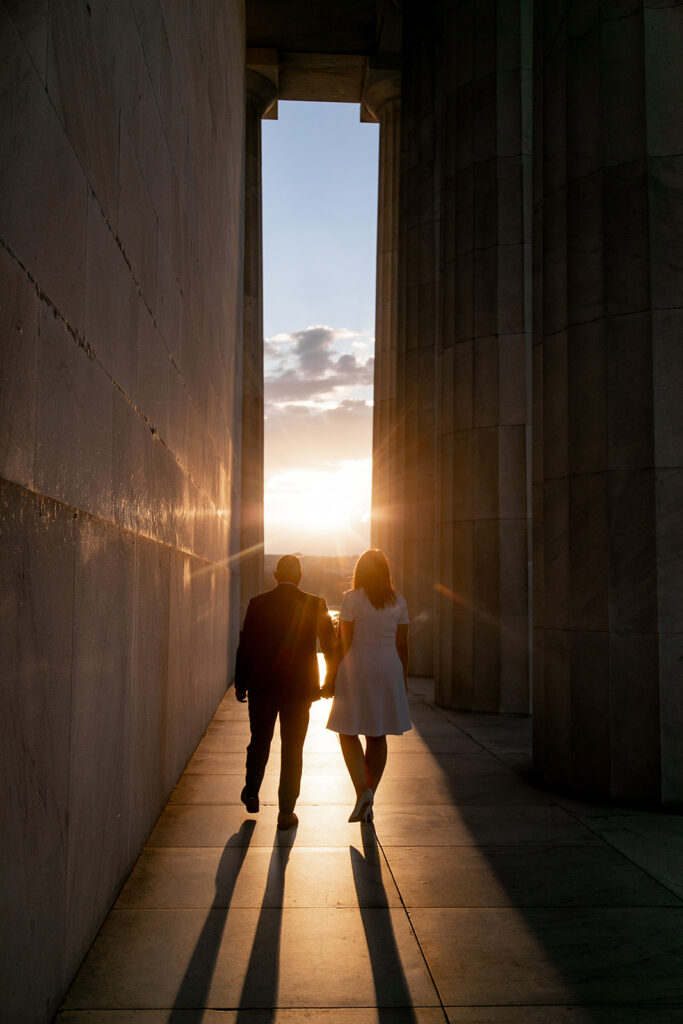 Engaged couple laughing and embracing at the Lincoln Memorial during iconic DC monument engagement session