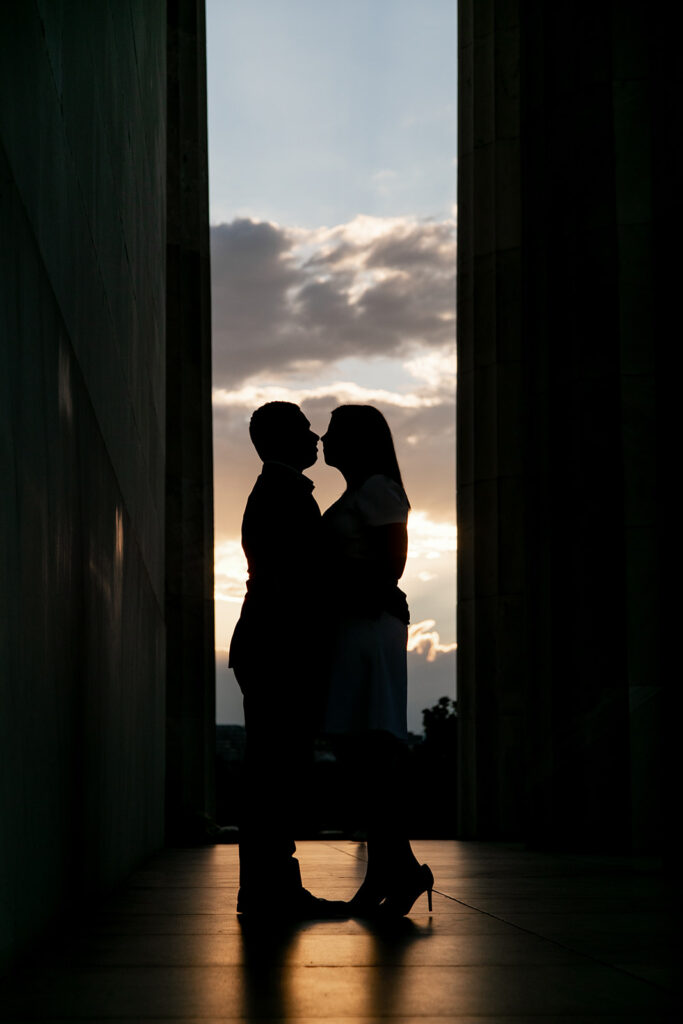 Golden hour glow surrounds DC couple during romantic Lincoln Memorial engagement photo session
