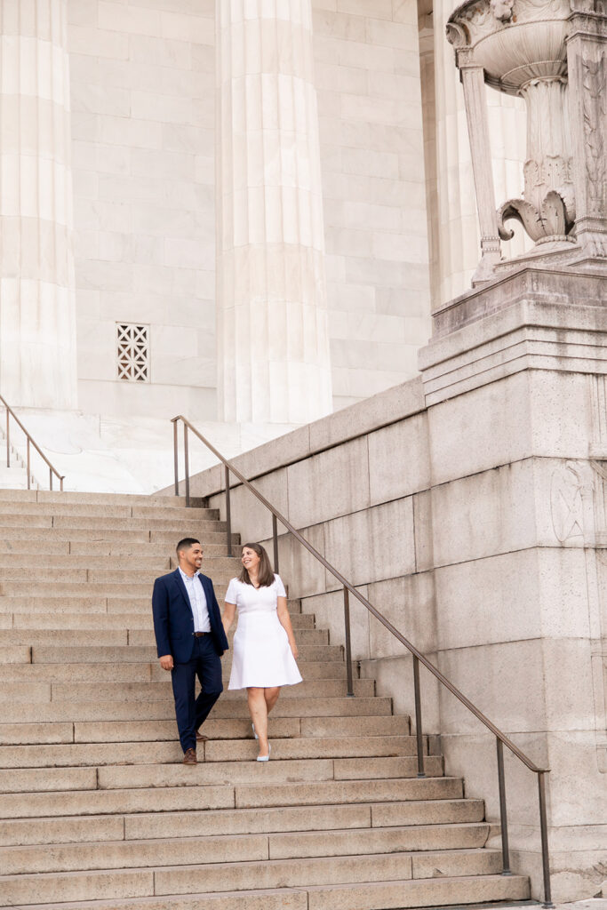 Engaged couple walking down the steps of the Lincoln Memorial in Washington, DC during a romantic engagement session