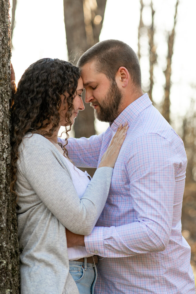Romantic close-up of couple resting foreheads together 