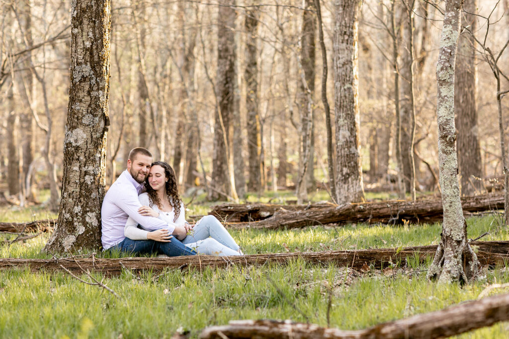 DC couple cuddling under the trees in during golden hour