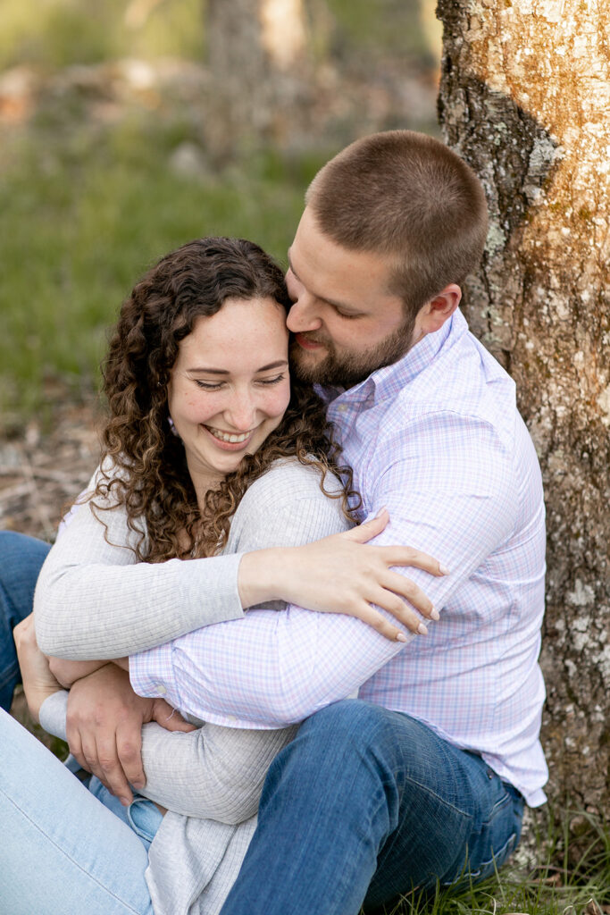 Joyful candid of engaged couple hugging and smiling during fall Shenandoah engagement session