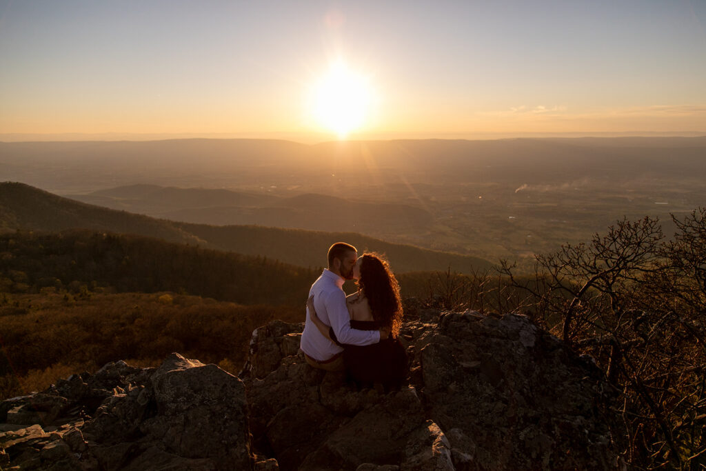 DC couple kissing at sunset with sweeping Shenandoah Valley views behind them