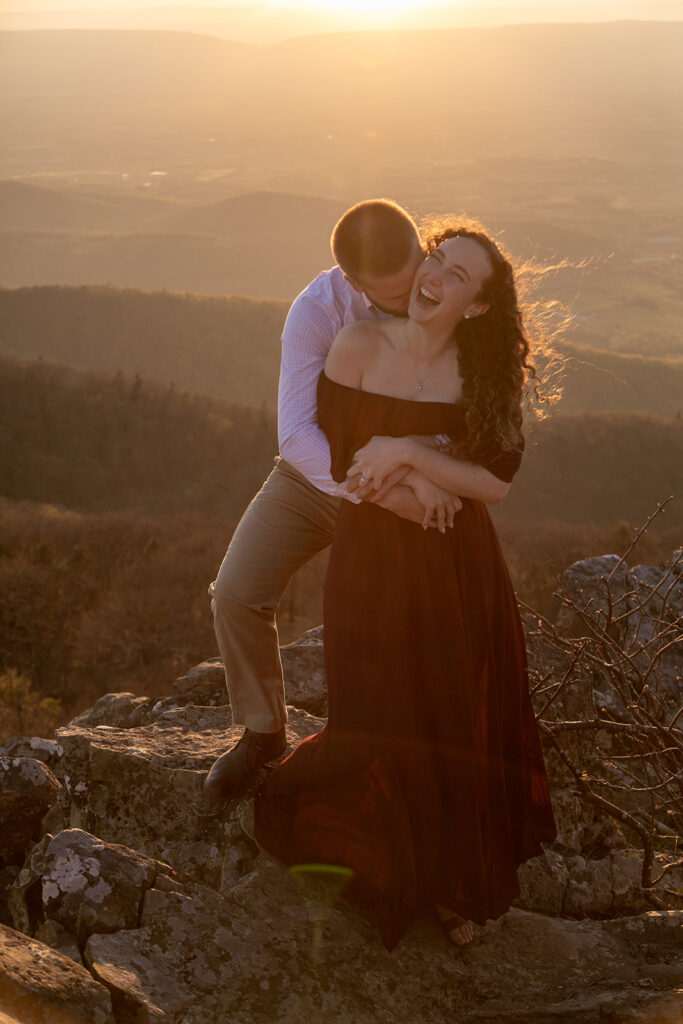 Romantic moment of DC couple hugging at golden hour during their fall Shenandoah engagement photos