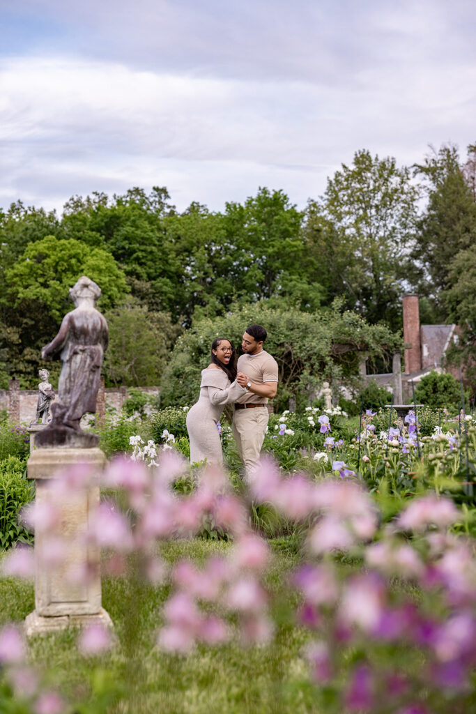 Engagement session portraits of a newly engaged couple in a garden setting near Washington DC