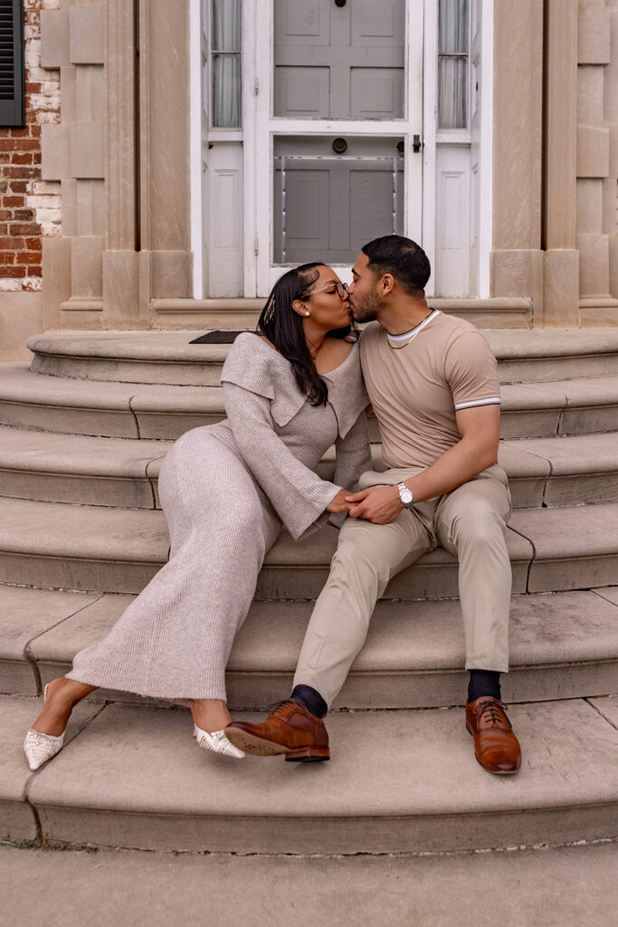Engaged couple kissing on stone steps during an engagement session near Washington DC