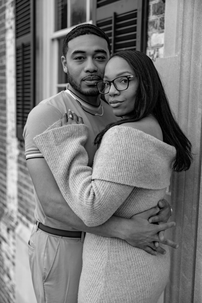 Black and white engagement portrait of a newly engaged couple near historic architecture in Washington DC