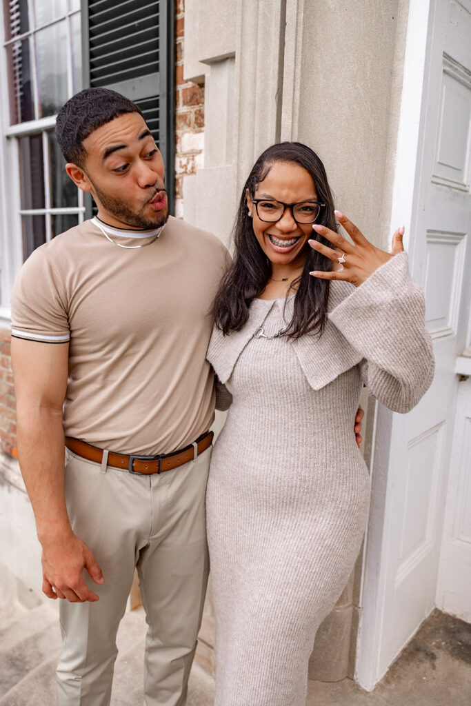 Newly engaged woman showing her engagement ring while celebrating after a surprise proposal near Washington DC