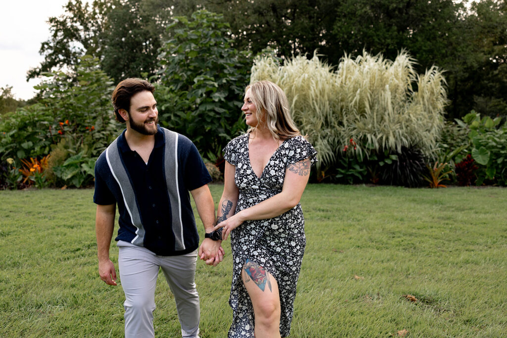 Newly engaged couple walking hand in hand during an engagement session at Meadowlark Botanical Gardens near DC
