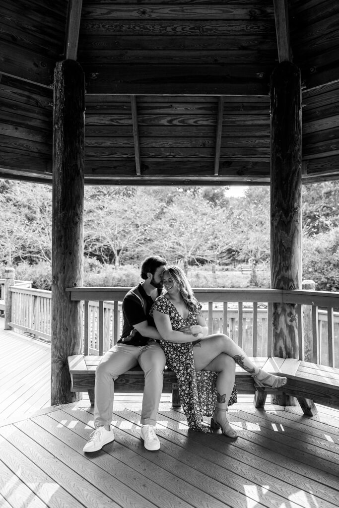 Wide black and white engagement photo of a couple celebrating their surprise proposal at Meadowlark Botanical Gardens near Washington DC