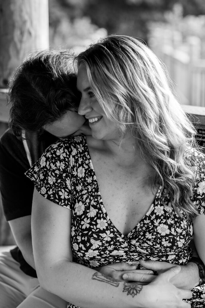 Black and white engagement photo of a newly engaged couple embracing after a surprise proposal at Meadowlark Botanical Gardens near Washington DC