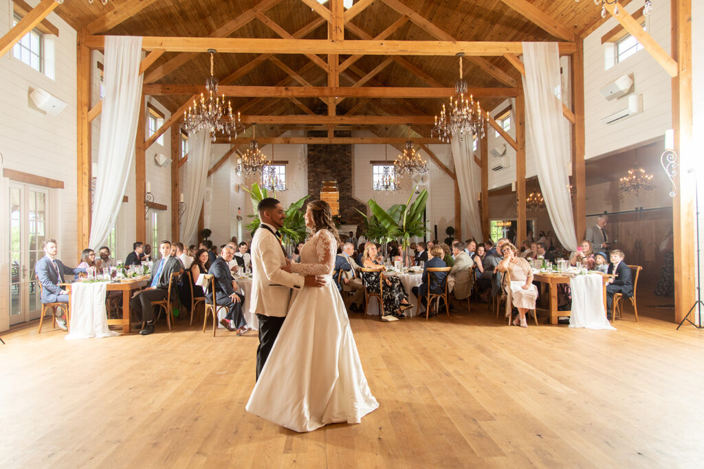 Bride and groom sharing their first dance in the reception hall at The Seclusion.