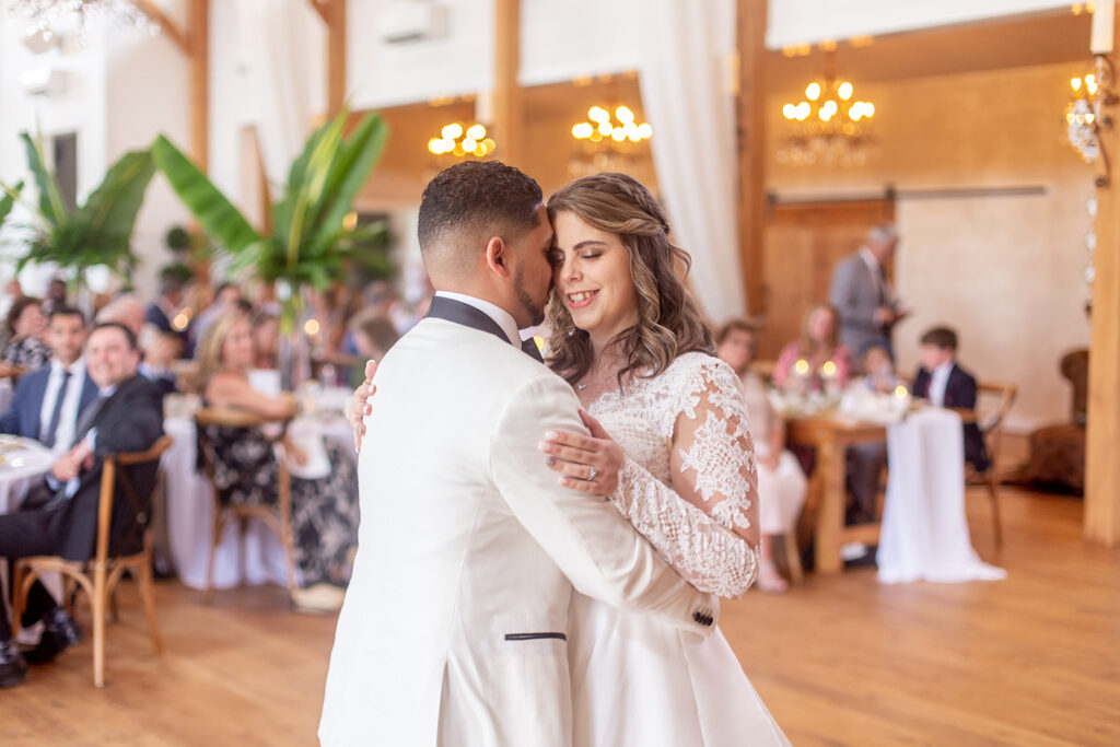 Close-up of bride and groom dancing together during their reception.