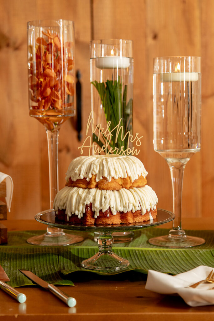 Bundt wedding cake with floating candle centerpieces and a custom Mr. & Mrs. cake topper.