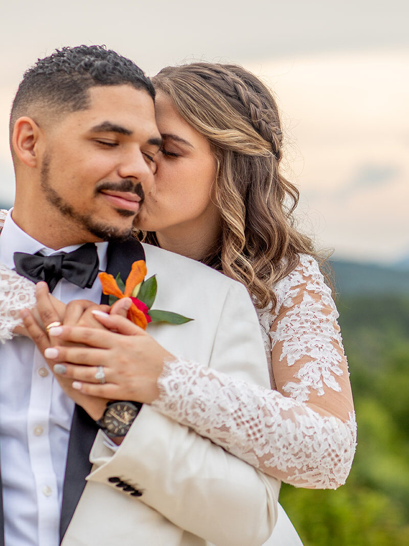 Bride hugging the groom from behind during sunset portraits at The Seclusion.