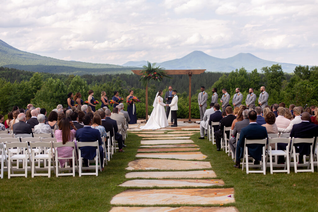 Wedding ceremony with guests seated and mountains in the background at The Seclusion.