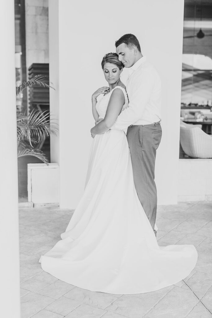 Couple embracing in a shaded outdoor corridor at the resort.