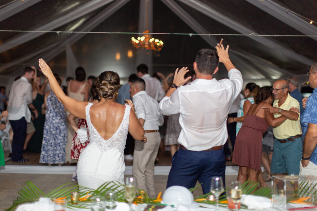 Couple dancing and watching their wedding reception.