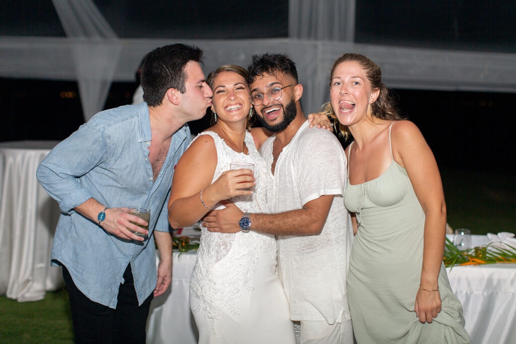 Bride taking a fun group photo with guests during the dance party.