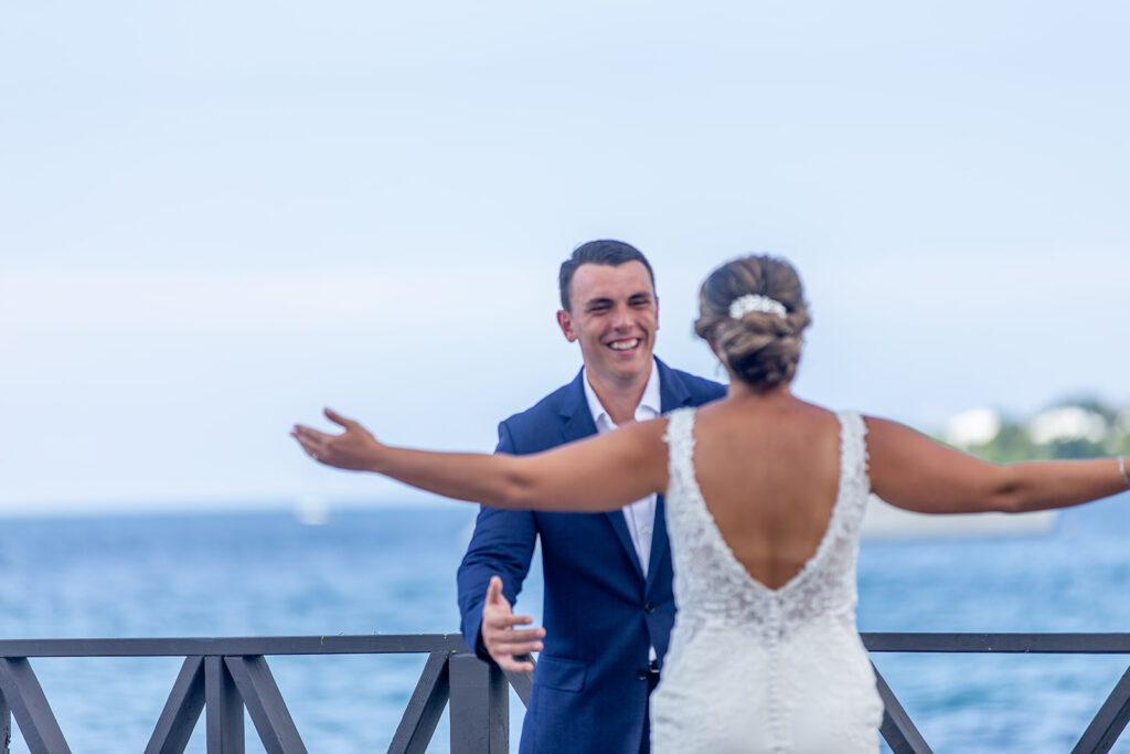 Groom smiling after seeing his soon to be bride for the first time.