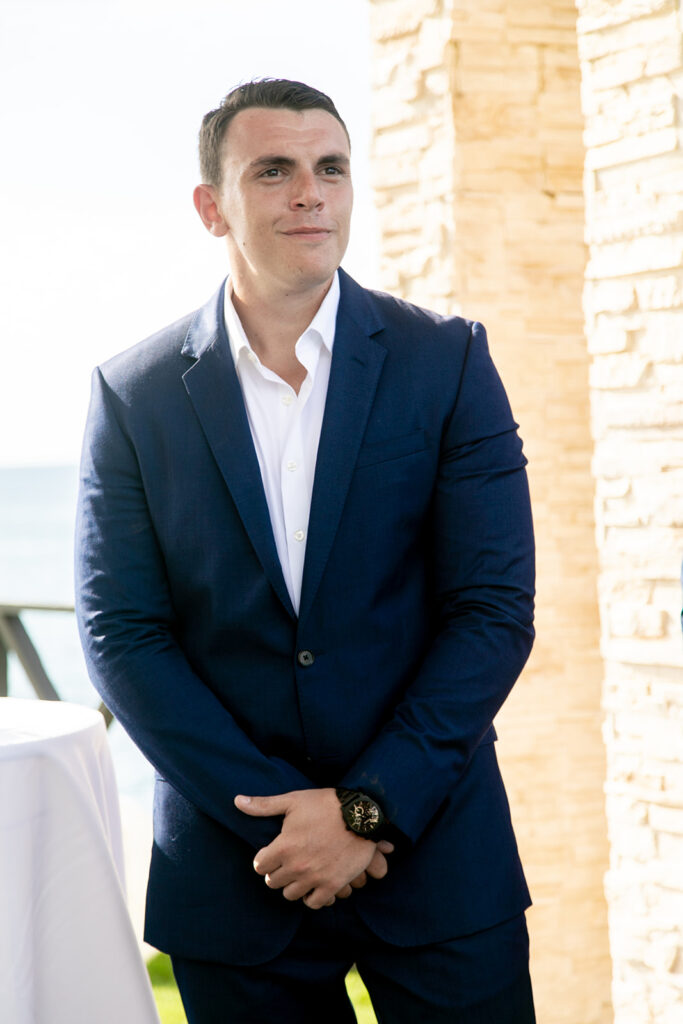 Groom standing at the altar waiting for the bride during their destination wedding.