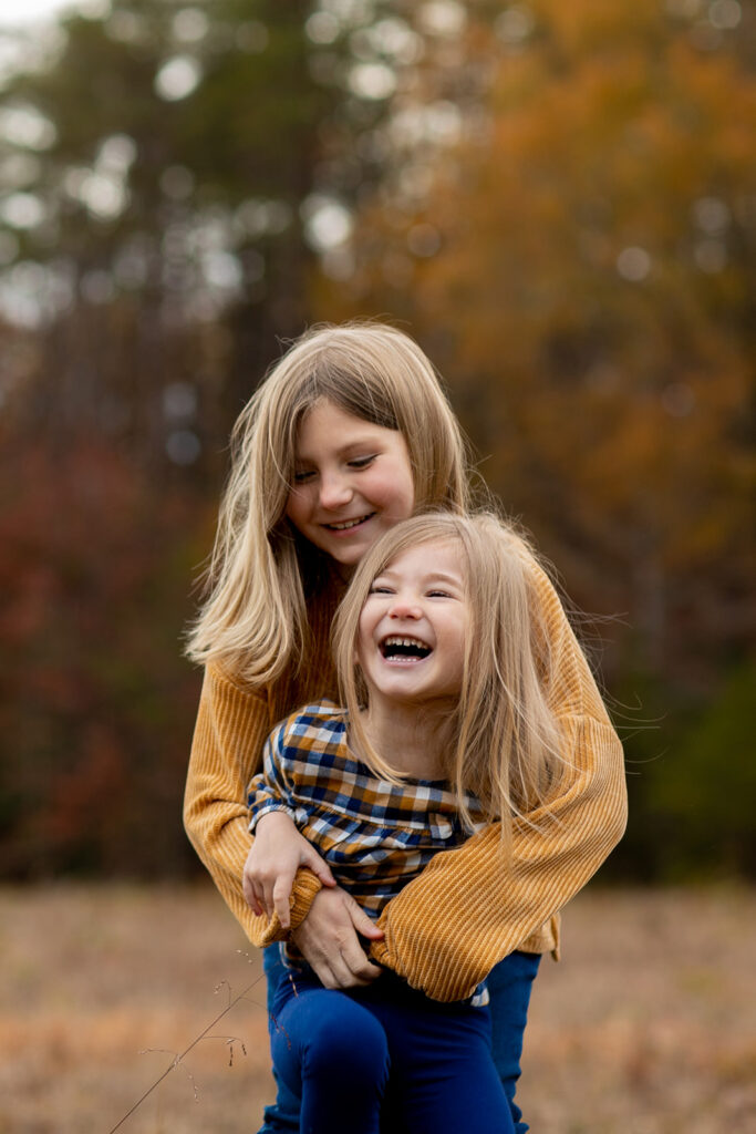 sisters laughing together in authentic photo moment