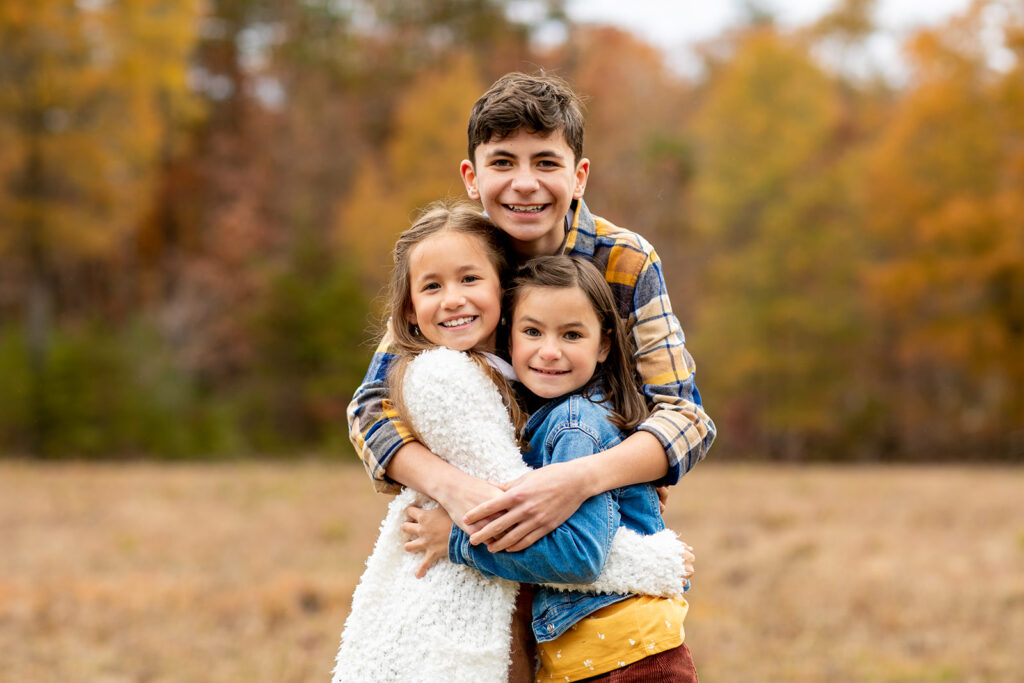 siblings embrace during their family mini session