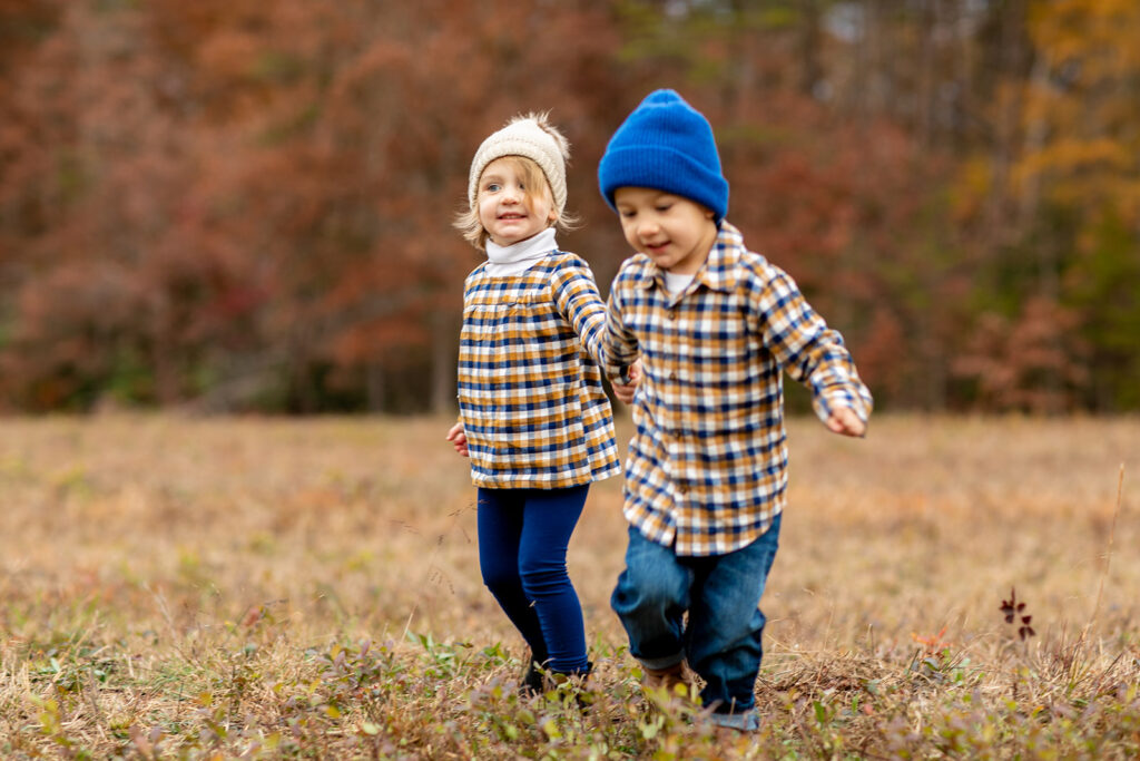 brother and sister play for candid family photography