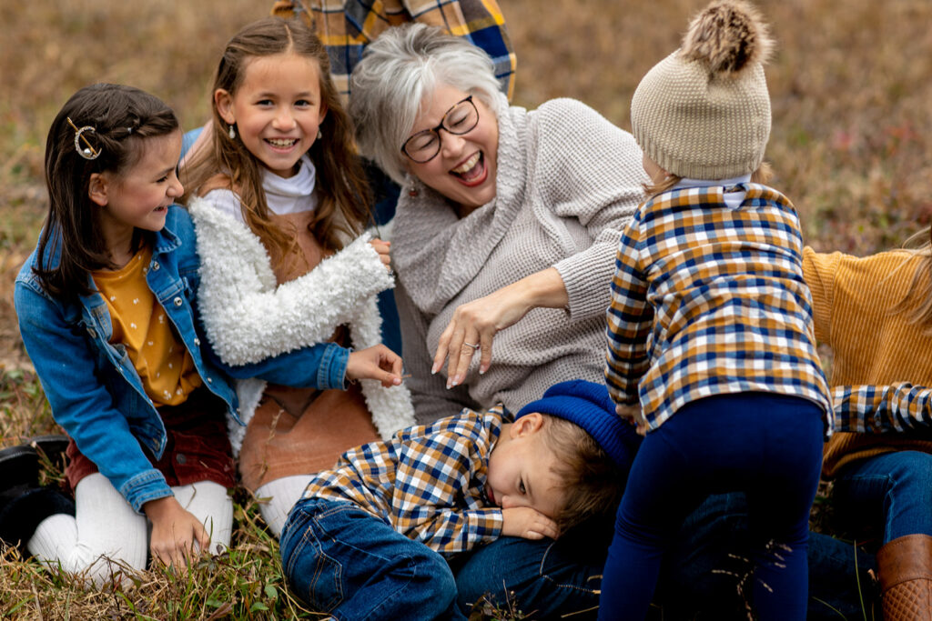 family laughing together during outdoor mini session