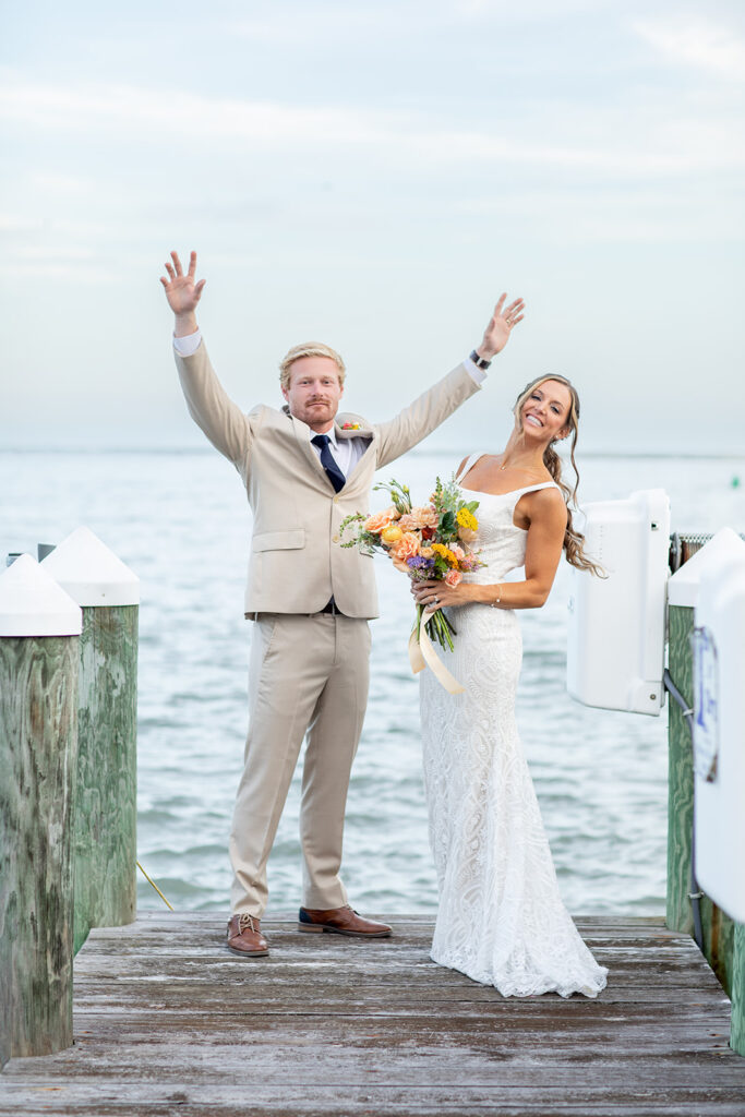 Romantic yet playful couple portraits at an Ocean City MD bayfront wedding