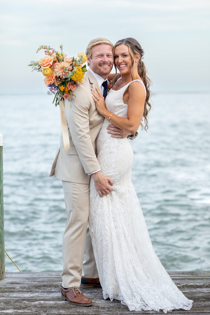 Romantic yet playful couple portraits at an Ocean City MD bayfront wedding