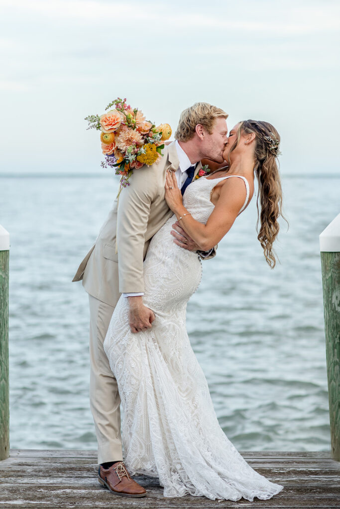 Romantic yet playful couple portraits at an Ocean City MD bayfront wedding