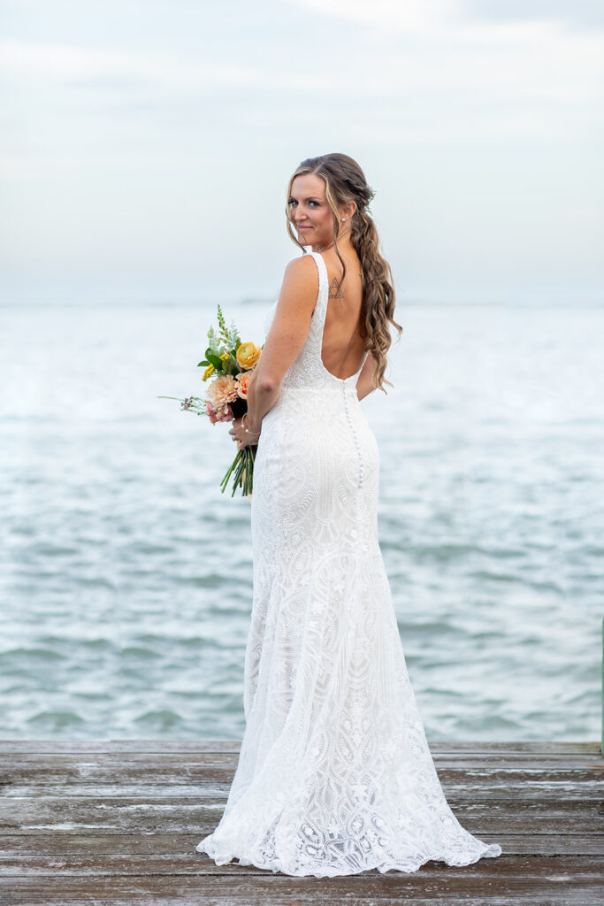 Romantic yet playful couple portraits at an Ocean City MD bayfront wedding