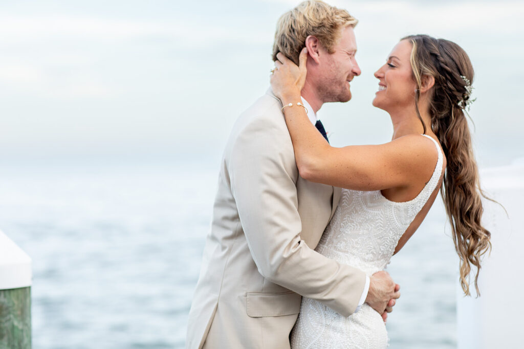 Romantic yet playful couple portraits at an Ocean City MD bayfront wedding
