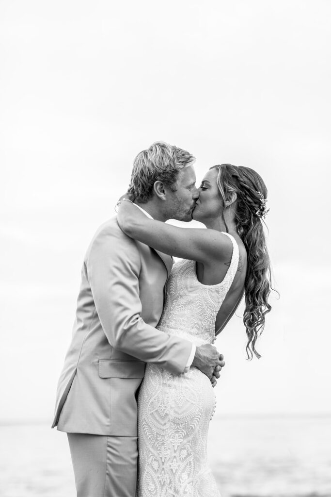 Romantic yet playful couple portraits at an Ocean City MD bayfront wedding