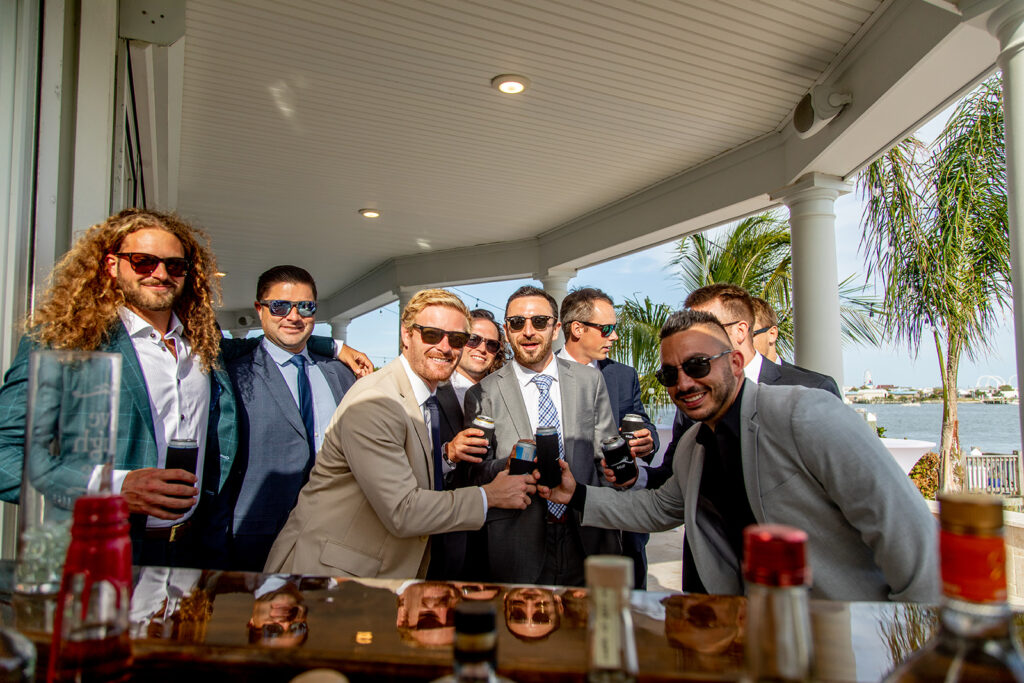 Groom getting ready with friends during a relaxed Ocean City MD beach wedding