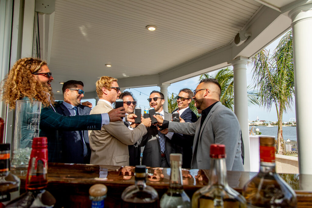 Groom getting ready with friends during a relaxed Ocean City MD beach wedding