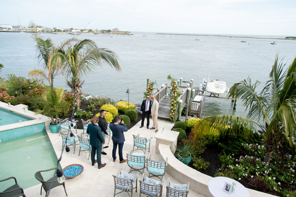 Groom getting ready with friends during a relaxed Ocean City MD beach wedding