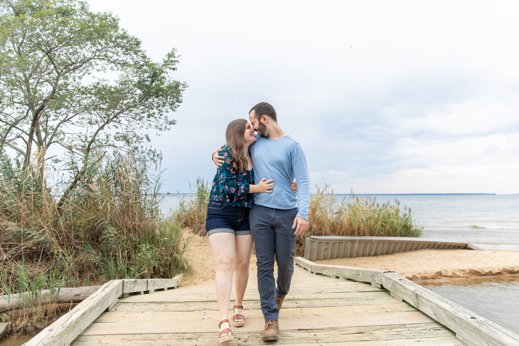 Engagement session at Terrapin Nature Park featuring a wooden bridge and coastal scenery near Washington DC