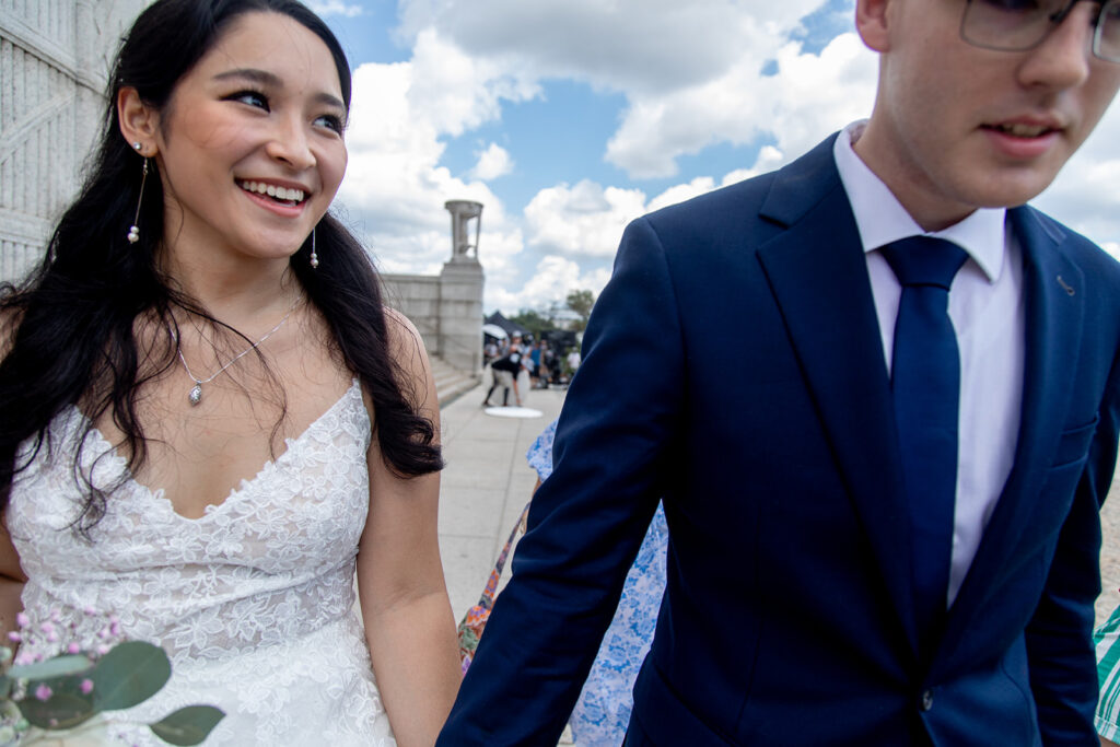 Bride and groom walking hand in hand at the Lincoln Memorial during DC elopement