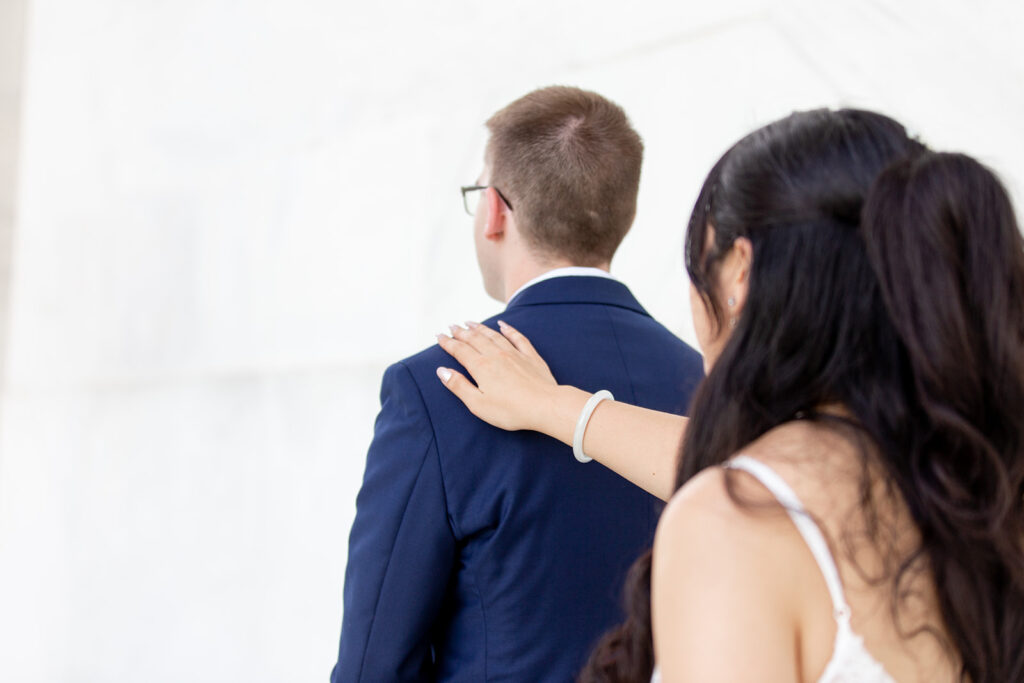 Bride taps groom’s shoulder during Lincoln Memorial first look DC elopement