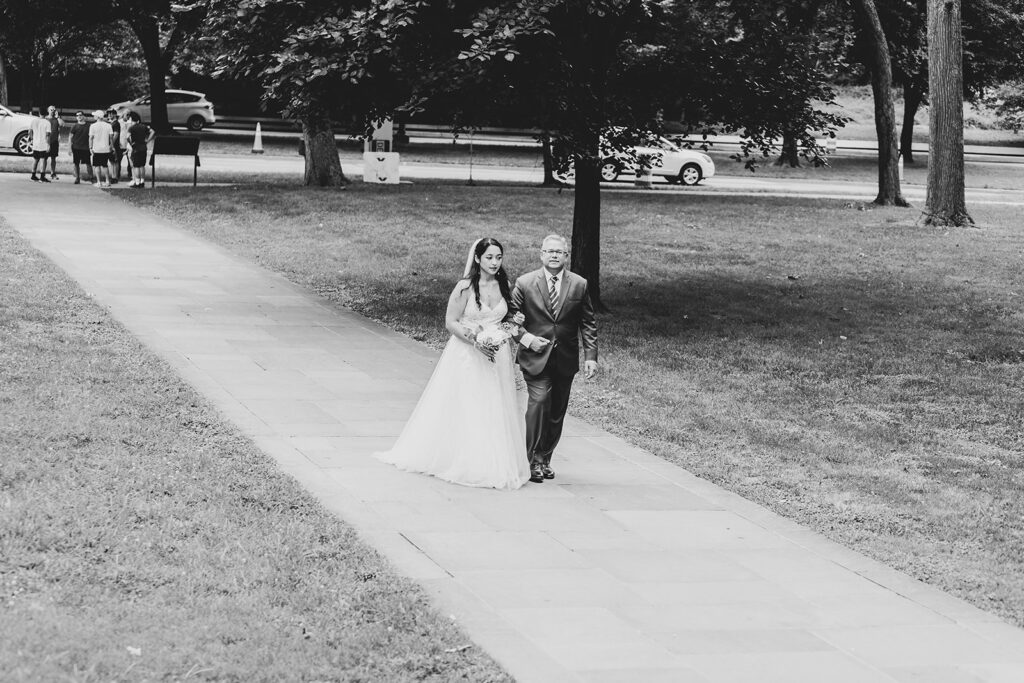 Bride and groom walking together along a path after their DC War Memorial elopement